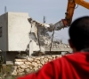 The occupation forces compel a Jerusalemite to demolish his own house