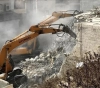 The occupation forces compel a Jerusalemite to demolish his house in Sur Baher