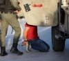 The occupation arrests four young men and steals a sum of money in Qalqilya