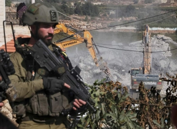 The occupation demolishes a house and a barn north of Jericho
