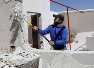 The occupation forces a Palestinian to demolish his home in Jabal Mukaber, Jerusalem