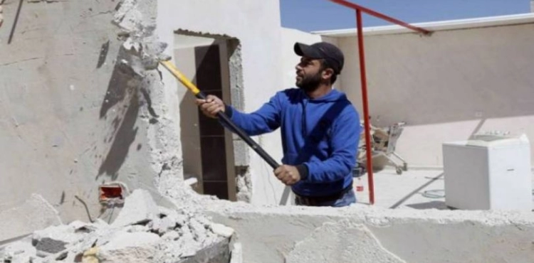The occupation forces a Palestinian to demolish his home in Jabal Mukaber, Jerusalem