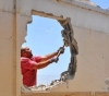The occupation forces a Jerusalemite to demolish his house in Al-Tur