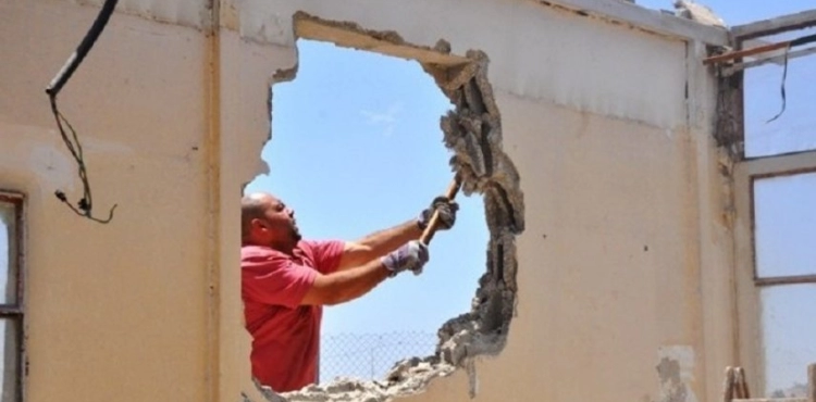The occupation forces a Jerusalemite to demolish his house in Al-Tur