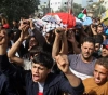 Gaza crowds spread the bodies of a child and a young man from the return procession