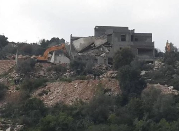 Israeli bulldozers demolish a building and a house under construction in Wadi Ara