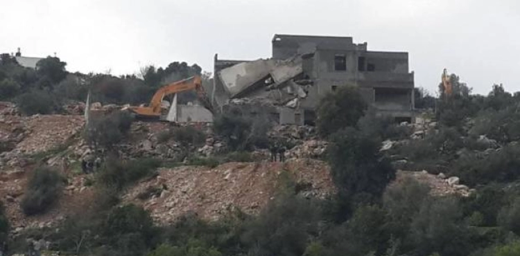 Israeli bulldozers demolish a building and a house under construction in Wadi Ara