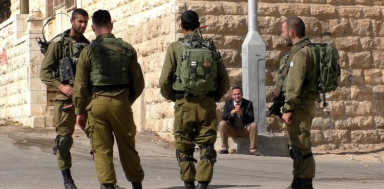 Israeli soldiers destroy a shop near the Tomb of the Patriarchs