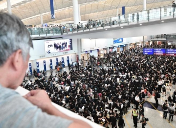 Thousands of protesters in Hong Kong sit in the airport