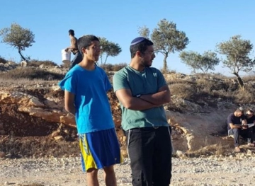 A settler assaulting farmers while harvesting olives east of Tulkarm
