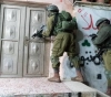 Israeli forces arrest citizens during separate raids in the West Bank