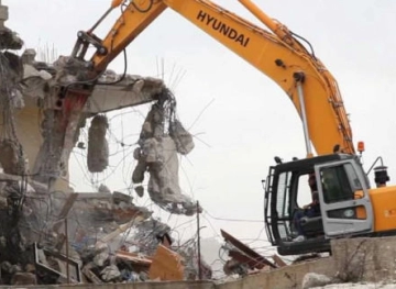 Israeli forces demolish a house in the industrial zone north of occupied Jerusalem
