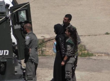 Occupation arrests a girl near the door of the column