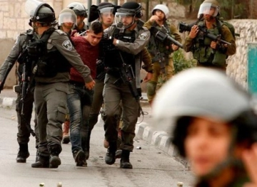 The occupation forces arrest two young men and boys, and raids houses in Ya`bad