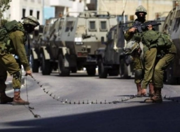 Sealing off the city of Qalqilya with heavy military checkpoints