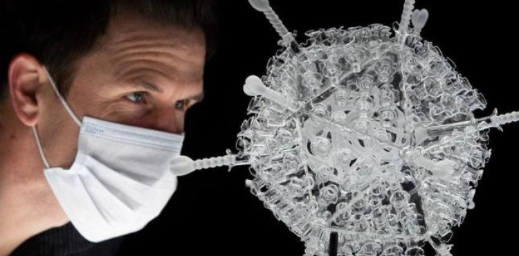 An artist creates a glass sculpture of the AstraZeneca vaccine