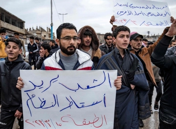 Syrians commemorate the 12th anniversary of their uprising against the regime